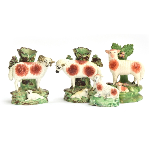 226 - A pair of Staffordshire pearlware spill vases in the form of a ewe and ram, each with lamb, 13cmH; t... 