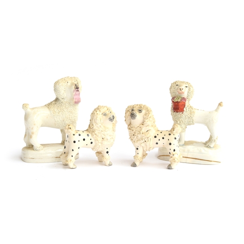 227 - Two pairs of 19th century Staffordshire 'lion clipped' poodles, one matched pair holding baskets in ... 