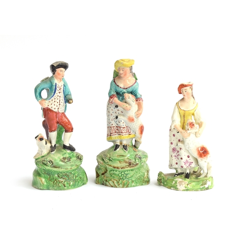 228 - A pair of 19th century Staffordshire pearlware shepherd and shepherdess figures (af), each on a natu... 