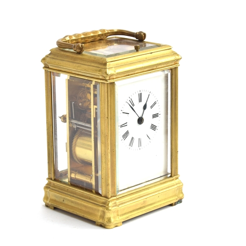 47 - A brass carriage clock with bevelled glass and white enamel dial and Roman numerals, repeat mechanis... 