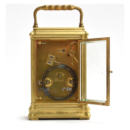 47 - A brass carriage clock with bevelled glass and white enamel dial and Roman numerals, repeat mechanis... 