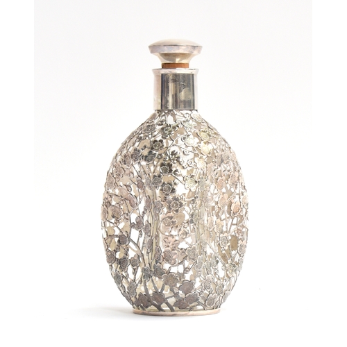 133 - A whiskey dimple bottle, with all over .950 silver prunus lattice, 22cm high