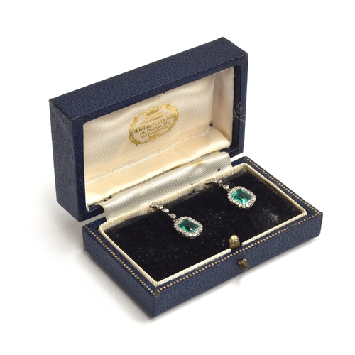 8 - A pair of Art Deco emerald and diamond earrings, screw backs, with emeralds surrounded by 20 diamond... 