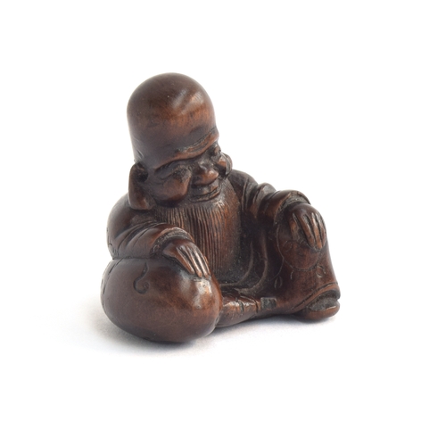 201 - A Japanese carved netsuke in the form of a sage, makers mark to base, 4cm high