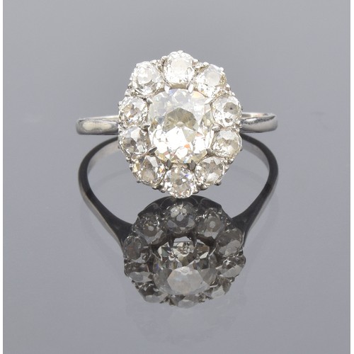 5 - A diamond cluster ring, with a large central diamond, approx. 1.13ct, surrounded by ten smaller diam... 
