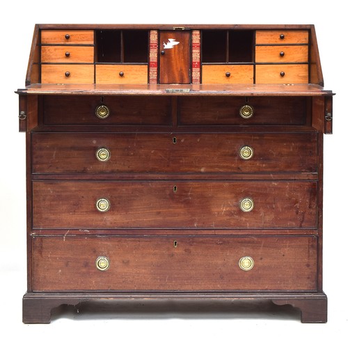 519 - A George III mahogany bureau, the fall front opening to a fitted interior above an arrangement of tw... 