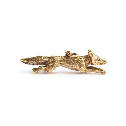 23A - A 9ct gold pendant in the form of a running fox, set with ruby eyes, 4.5cm long approx. 11.2g