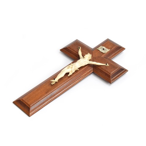 159A - A 19th century carved ivory Corpus Christi mounted on a wooden cross, 17 x 30cm