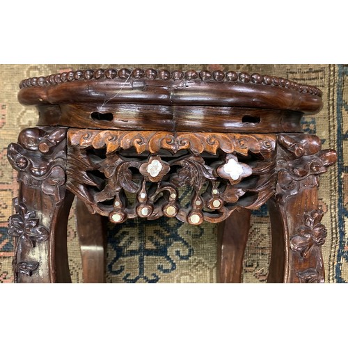 626 - A 19th century Chinese hardwood and mother of pearl jardiniere stand, with circular inset marble top... 