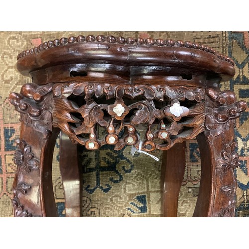 626 - A 19th century Chinese hardwood and mother of pearl jardiniere stand, with circular inset marble top... 