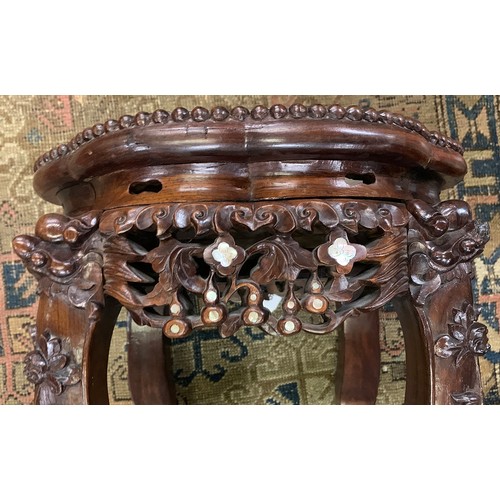 626 - A 19th century Chinese hardwood and mother of pearl jardiniere stand, with circular inset marble top... 