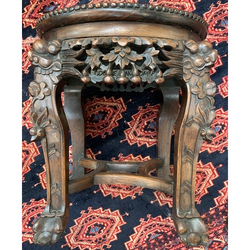 624 - A 19th century Chinese hardwood jardiniere stand, with circular inset marble top, on four carved leg... 