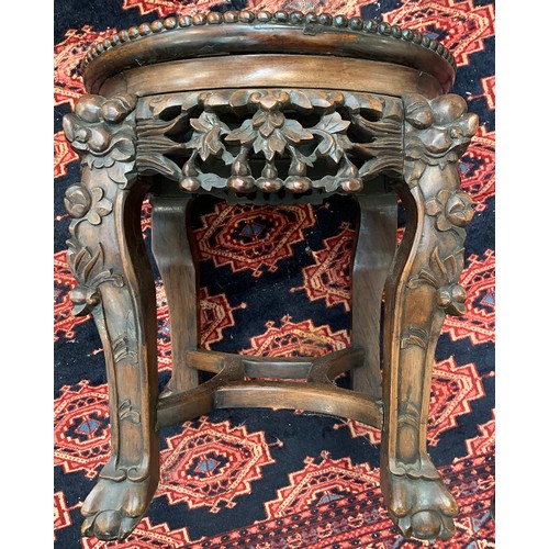 624 - A 19th century Chinese hardwood jardiniere stand, with circular inset marble top, on four carved leg... 