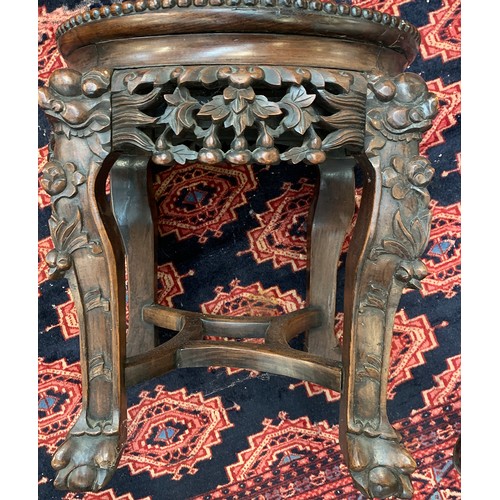 624 - A 19th century Chinese hardwood jardiniere stand, with circular inset marble top, on four carved leg... 