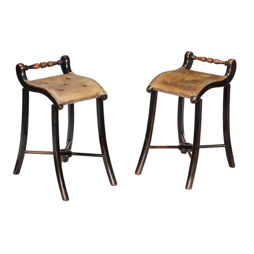 679 - A pair of late Victorian ebonised Cellists' stools, now leather button upholstered, on swept legs un... 