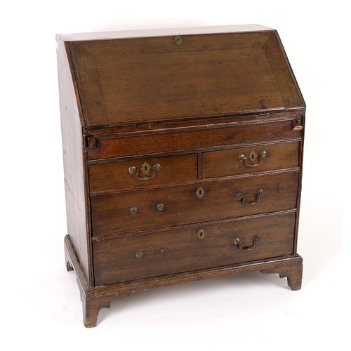 602 - A George II and later oak bureau, the fall enclosing a fitted interior with well, over two short and... 