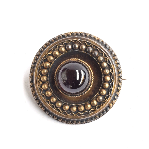 14 - A 15ct gold Victorian Etruscan Revival brooch, set with central garnet cabochon, locket to reverse, ... 