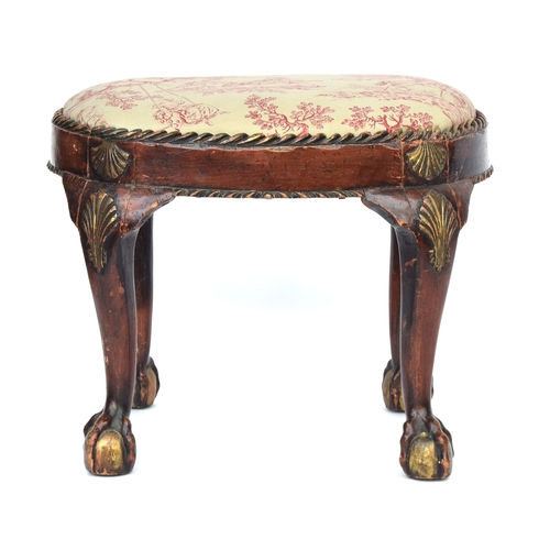 661 - A George II style painted and parcel gilt carved footstool, the oval drop in seat set within a gadro... 