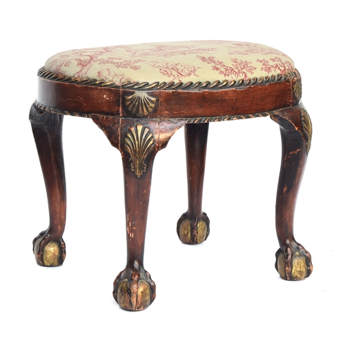 661 - A George II style painted and parcel gilt carved footstool, the oval drop in seat set within a gadro... 