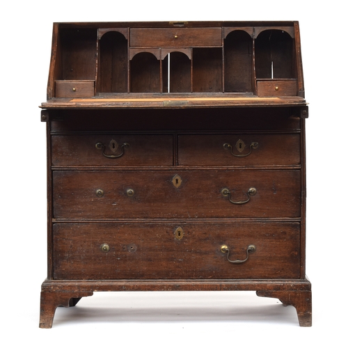 602 - A George II and later oak bureau, the fall enclosing a fitted interior with well, over two short and... 