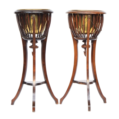 628 - A pair of 19th century urn stands each with removable brass bowl surrounded by beaded swags, on 3 sw... 