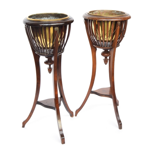 628 - A pair of 19th century urn stands each with removable brass bowl surrounded by beaded swags, on 3 sw... 