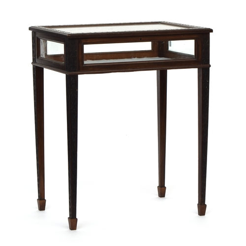 641 - A glazed display table with blind fretwork border and square tapered legs with spade feet, 60cm wide... 