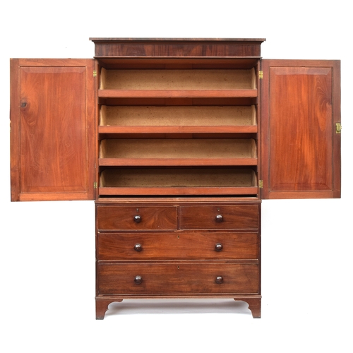 597 - A Regency mahogany linen press, pediment top over fielded panel doors opening to four slides on a ba... 