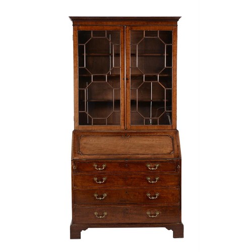 599 - A George III mahogany bureau bookcase, circa 1800, the glazed section with moulded beadings above th... 