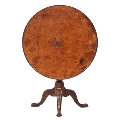 618 - A George III mahogany tripod table, the circular tilt-top with moulded edge, on a turned stem on she... 