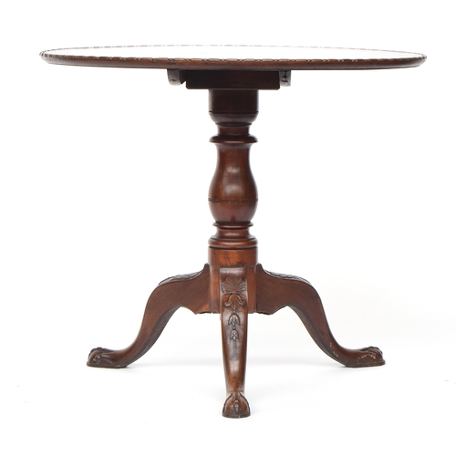 618 - A George III mahogany tripod table, the circular tilt-top with moulded edge, on a turned stem on she... 