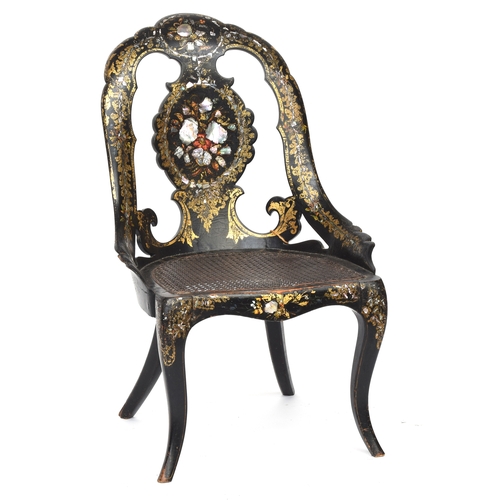 662 - A Victorian papier mache ebonised and parcel gilt chair, inlaid with mother of pearl, caned seat