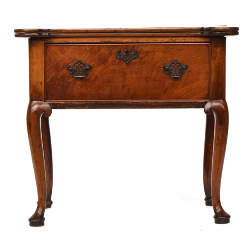 606 - A George II and later mahogany tea table in the Irish style, the folding top with rounded castellate... 