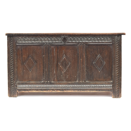 580 - A late 17th century three panel oak coffer, two plank top over guilloche carved frieze and lozenge d... 