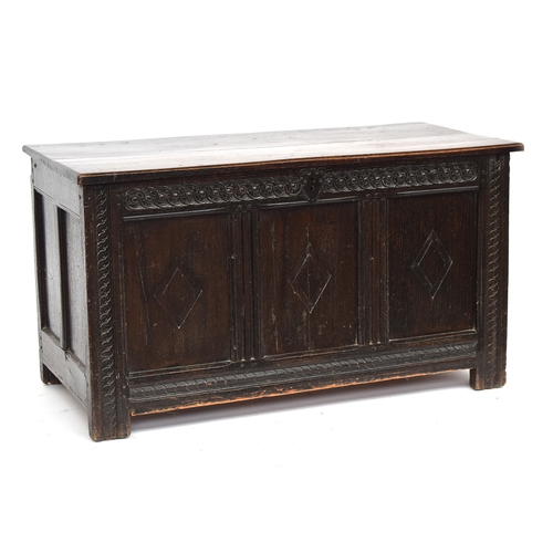 580 - A late 17th century three panel oak coffer, two plank top over guilloche carved frieze and lozenge d... 