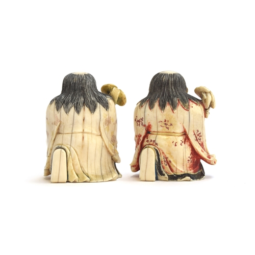 247 - Two Japanese netsukes depicting kneeling priests holding staves, each 6.5cm high