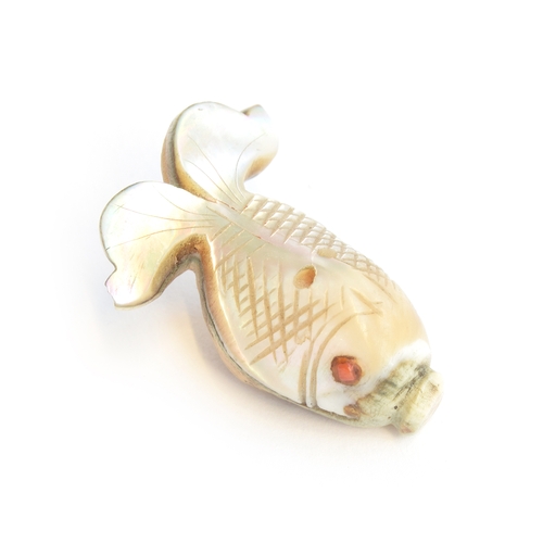 252 - A 19th century Japanese mother of pearl netsuke in the form of a fish, set with coral eye, 4cm long