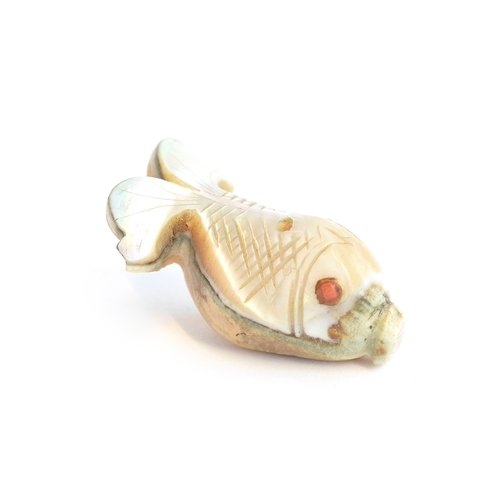 252 - A 19th century Japanese mother of pearl netsuke in the form of a fish, set with coral eye, 4cm long