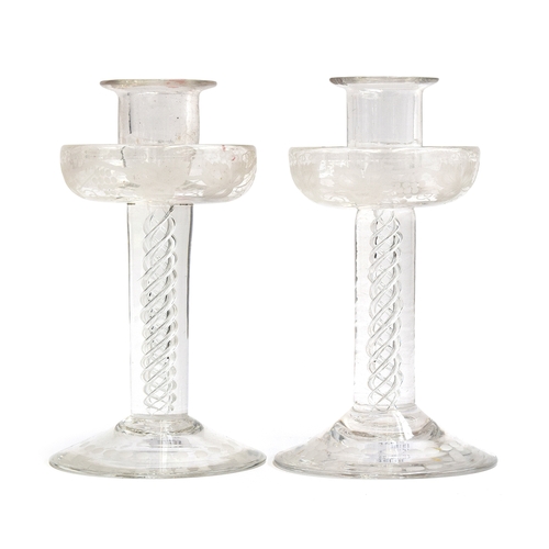 294 - A pair of Victorian glass candlesticks, the drip pans etched with grapes and vines above airtwist st... 