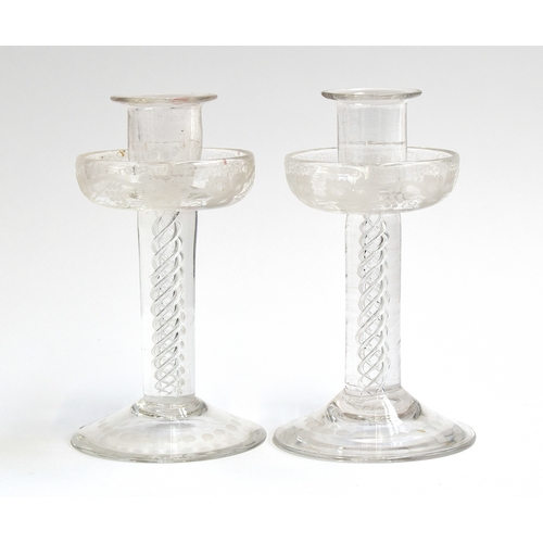 294 - A pair of Victorian glass candlesticks, the drip pans etched with grapes and vines above airtwist st... 