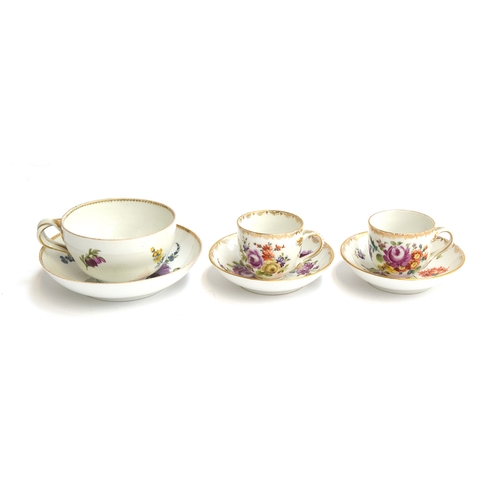 282 - A pair of 19th century teacups and saucers with floral spray decoration, gilt swag decoration to rim... 