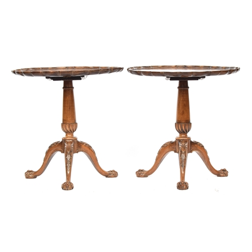 617 - A pair of George II style mahogany tripod tables, each with shaped pie crust tilt top on a gun barre... 