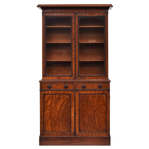 601 - A Victorian gonçalo alves glazed bookcase cabinet, the moulded pediment top over two glazed doors, t... 