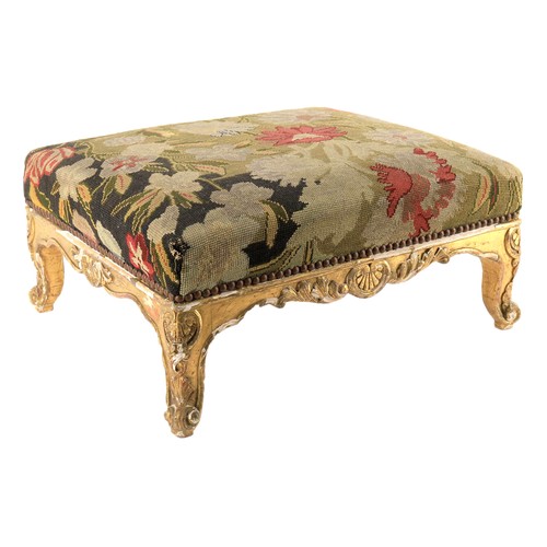 660 - A giltwood and gesso footstool in Louis XV style, needlework seat above scroll carved frame, 54cm lo... 