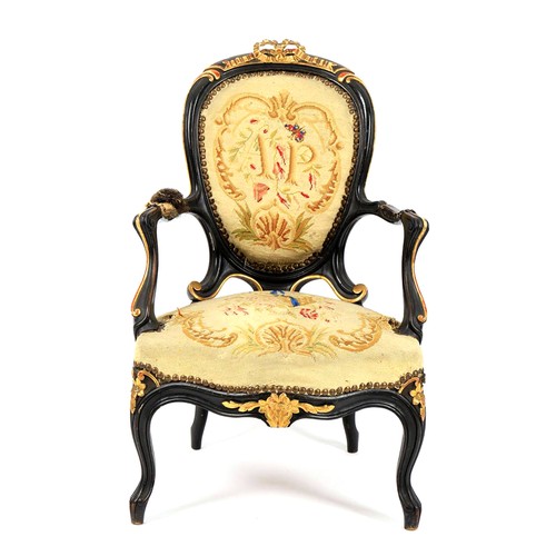 663 - A Victorian ebonised and parcel gilt child's fauteuil, second half 19th century, with a ribbon carve... 