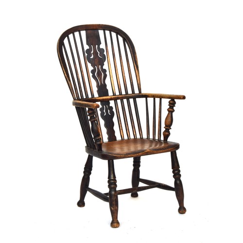 666 - A 19th century ash and elm high back Windsor chair, probably Lincolnshire, pierced 'Christmas tree' ... 