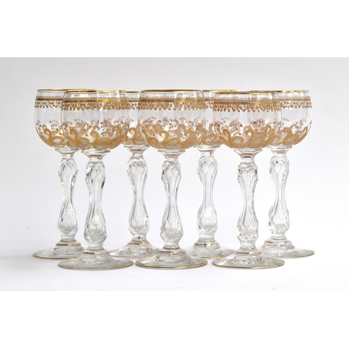 299 - A set of seven St Louis crystal wine glasses with gilded foliate design, each 17cm high