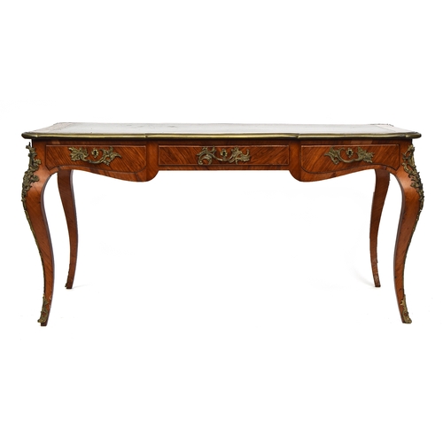 645 - A French Louis XV bureau plat writing table, with ormolu mounts, the top inset with a gilt tooled le... 