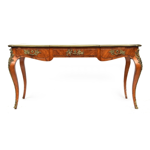 645 - A French Louis XV bureau plat writing table, with ormolu mounts, the top inset with a gilt tooled le... 