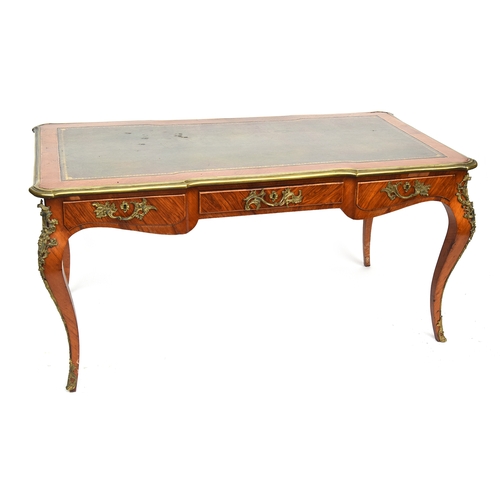 645 - A French Louis XV bureau plat writing table, with ormolu mounts, the top inset with a gilt tooled le... 